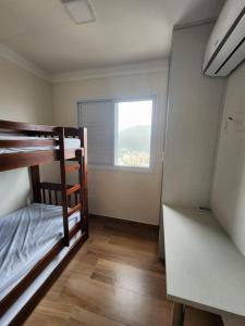 a room with two bunk beds and a window at Lazer de resort e vista marcante in Guarujá +29 photos