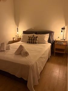 a bedroom with a large bed with white sheets and pillows at Kyveli Apartment in Karistos