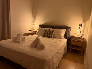 a bedroom with a large white bed with two pillows at Kyveli Apartment in Karistos +9 photos
