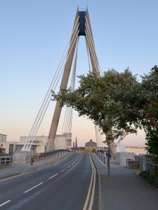 a bridge over a road with trees on the side at Lethbridge Villa 49 3-bedroom Apartment with private HOT TUB,Fibre WiFi, free parking, sleeps 6 in Southport +54 photos