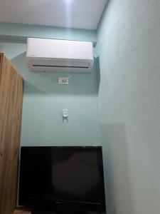 a room with a heater and a television in a room at Calm & Green Retreat in Baks-Rrjoll