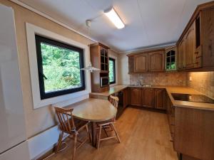 a kitchen with a table and chairs and a window at Comfortable Apartment Sleeps 3 Near Kristiansand City Center in Kristiansand