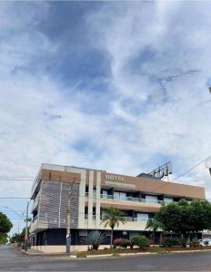 a building on a street with a cloudy sky at Casablanca Palace Hotel Frutal MG in Frutal