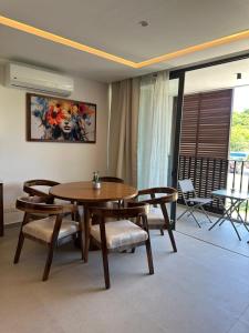 a dining room with a wooden table and chairs at Arama Bay Relaxation, Luxury and Elegance by the Sea in Bucerías