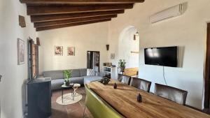 a living room with a couch and a table at Cortijo J&S Juan Salvador in Málaga