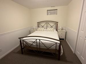 a bedroom with a bed with white sheets and pillows at Luxurious Lakefront Cottage, Sleeps 12 in Bewdley