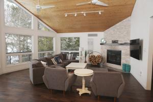 a living room with a couch and a fireplace at Luxurious Lakefront Cottage, Sleeps 12 in Bewdley