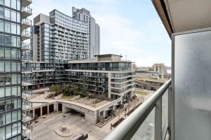 a view of a large building from a balcony at Charming Condo w Private Patio in Quiet Capreol in Toronto
