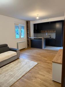 a living room with a couch and a kitchen at Family Apartment Durmitor in Žabljak