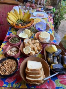 a table with a bunch of different types of food at Pousada Casa Cria in Camaçari