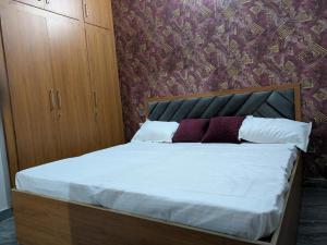a bedroom with a bed with white sheets and pillows at Monk stay in Jaipur
