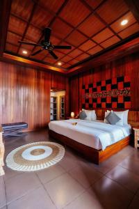 a bedroom with a large bed and a ceiling at Tattva Ubud Retreat & Wellness in Ubud +100 photos