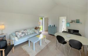 a living room with a blue couch and a table at 3 Bedroom Lovely Home In Gedser in Gedser