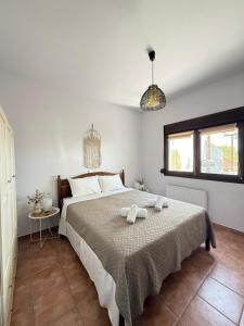 a bedroom with a bed with two towels on it at Vines horizon in Alexandroupoli +3 photos