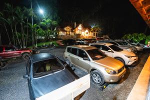 a row of cars parked in a parking lot at night at San Rafael Casa Patronal in Cobán