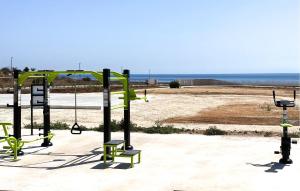 an empty playground with a view of the ocean at Stunning Apartment In Marzamemi in Marzamemi