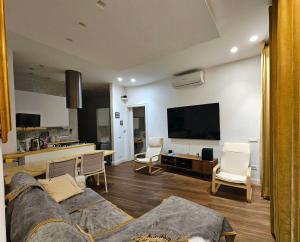 a living room with a couch and a tv at Casa Bianca Luino Terrace View in Luino