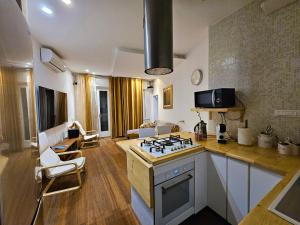 a kitchen with a stove and a living room at Casa Bianca Luino Terrace View in Luino