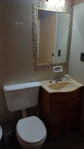 a bathroom with a toilet and a sink and a mirror at Mallorca in Jesús María