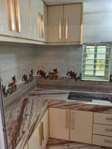 a kitchen with wooden cabinets and a counter top at Rajmaya Tower in Sylhet