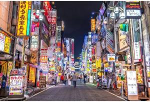 a street in an asian city at night at Newly opened! 4 minutes on foot from Shin-Okubo station in Tokyo