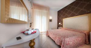 a hotel room with a bed and a sink at Hotel Acquamarina in Bellaria-Igea Marina +89 photos