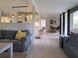 a living room with a couch and a table at 4 person holiday home in Gilleleje in Gilleleje