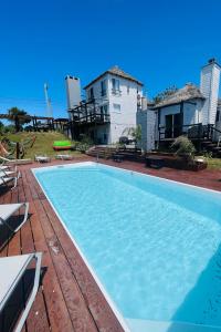 a large swimming pool in front of a house at Las Totoras PDD in Punta Del Diablo