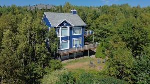 an aerial view of a blue house in the woods at Bleuzen chalet entier in Petite-Rivière-Saint-François