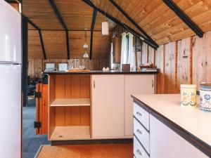 a kitchen with wooden walls and a counter top at Spacious Retreat with View - By Traum Ferienwohnungen in Blåvand