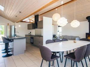 a kitchen and dining room with a table and chairs at Luxury Beach House with Spa - By Traum Ferienwohnungen in Sjølund