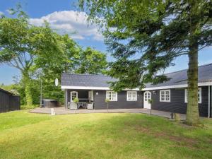 a house with a large yard in front of it at 6 person holiday home in Thyholm-By Traum in Thyholm