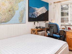 a bedroom with a bed and a desk with a computer at 6 person holiday home in Thyholm-By Traum in Thyholm