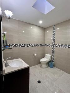 a bathroom with a sink and a toilet in it at House near IMSS Trinidad Santa Cruz Tlaxcala in Santa María Atlihuetzián