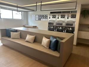 a couch in a store with pillows on it at ART STUDIO VISTA Mar FRONTAL ARMAÇAO PITUBA in Salvador