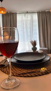a glass of wine sitting on a table with a plate at Duna & Mar I Concon in Concón