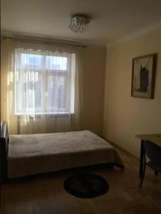 a bedroom with a bed in front of a window at Luxury Dana's City Centre Apartment in Kaunas