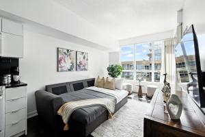 a bedroom with a bed and a large window at Modern Lakefront Escape Walk to Waterfront in Toronto +21 photos