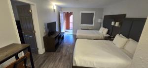 a hotel room with two beds and a television at Park Inn by Radisson Osoyoos in Osoyoos +11 photos