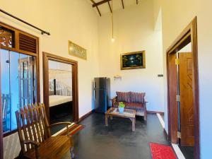 a living room with a couch and a chair at Oceanic Bliss in Weligama