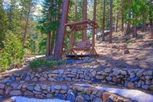 two chairs sitting in a swing in a forest at NVH0823 - Sadies Hustle home in Zephyr Cove