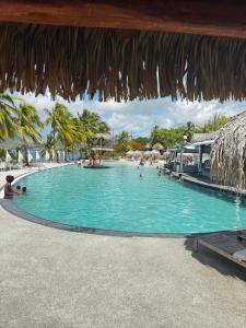 a swimming pool at a resort with people in it at Dayana Diamond in Le Diamant