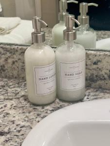 three bottles of hand soap sitting on a bathroom sink at Self Chk-In 10mins to Ft Cavazos in Killeen