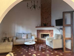 a living room with a couch and a fireplace at Hotel Boutique Casa Xicotl in Xico