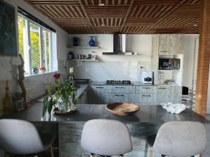 a kitchen with a table and some chairs in it at Kreolia Blue-Waters in Trou d'Eau Douce