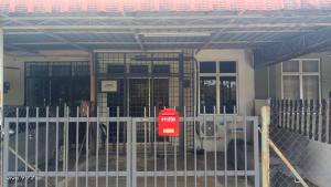 a gate with a sign in front of a building at Inap Desa SBJ in Tumpat