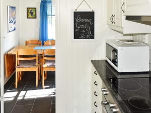 a kitchen with a table and a dining room at 5 person holiday home in Oksvoll in Oksvoll