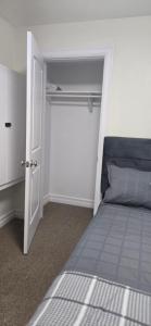a bedroom with a bed and an open door at Cozy Basement Suite in Lower Sackville +5 photos