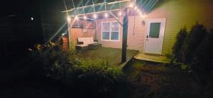 a house with a porch with a couch and lights at Cozy Basement Suite in Lower Sackville