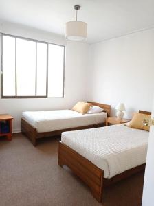 a room with two beds and two windows at Refugio Los Andes con Hot Tub in San Esteban +20 photos